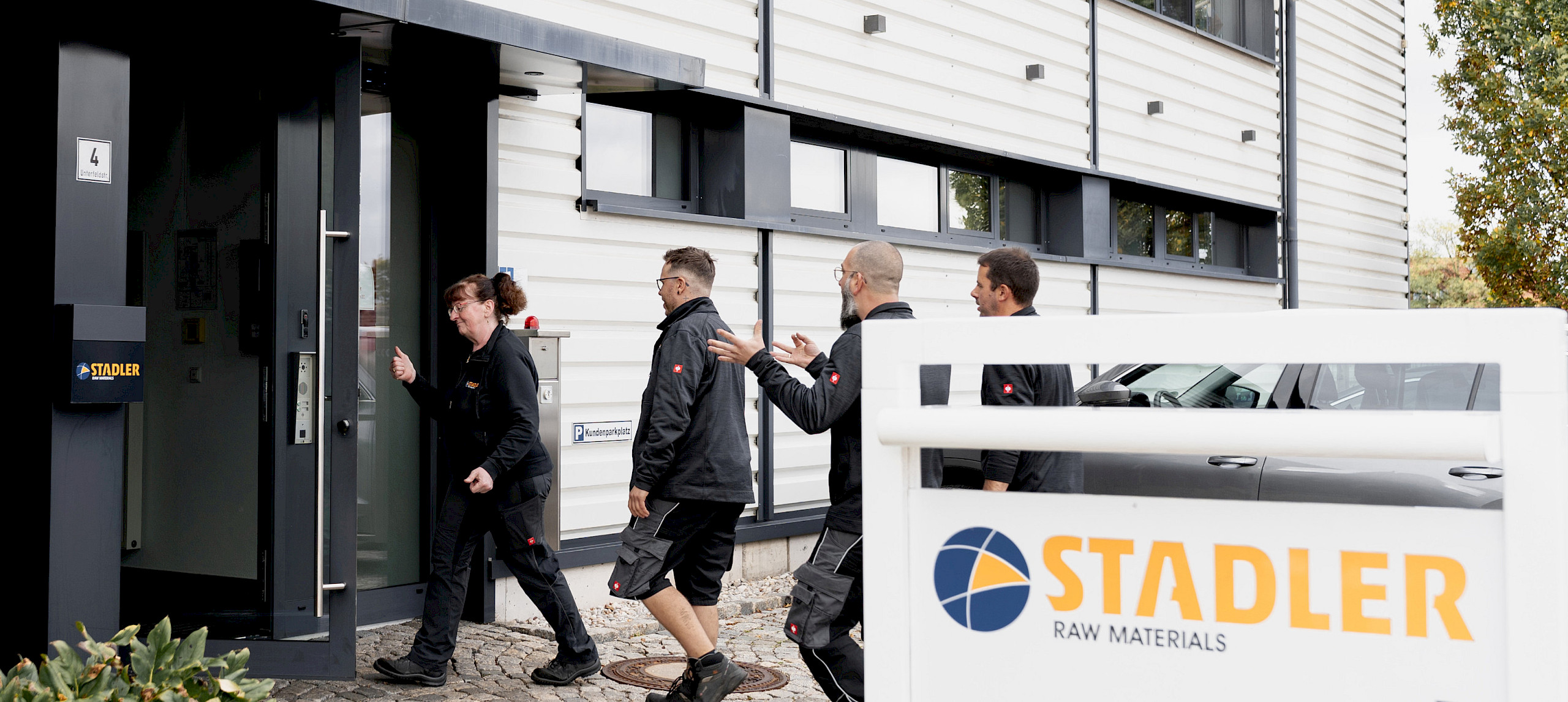 {"0":"Eine Gruppe von Menschen in Arbeitskleidung geht in ein Gebäude. Ein Schild mit der Aufschrift „Stadler Raw Materials“ ist im Vordergrund zu sehen.","1019":"A group of people in work clothes is entering a building. A sign with the inscription "Stadler Raw Materials" can be seen in the foreground."}